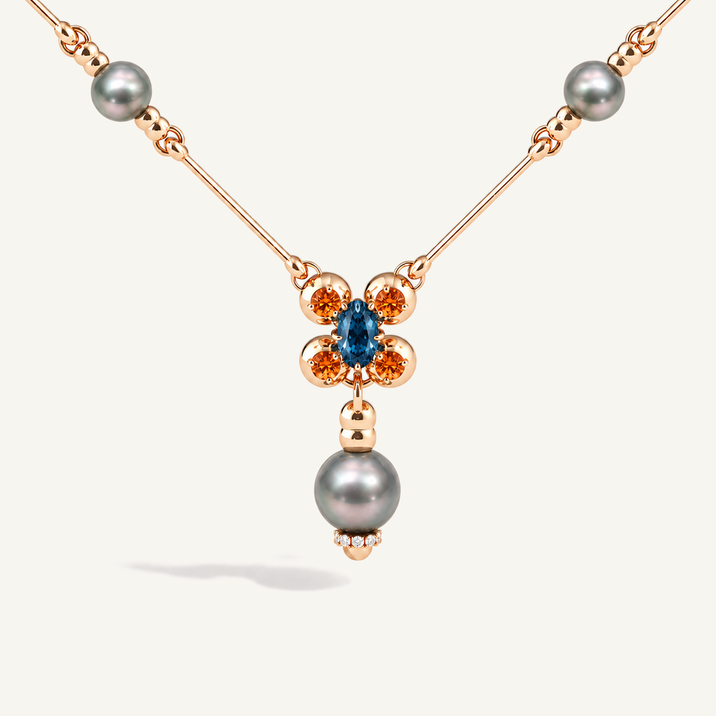 Barbelle necklace with grey Tahitian pearls, London blue topaz and mandarin garnets — front detail