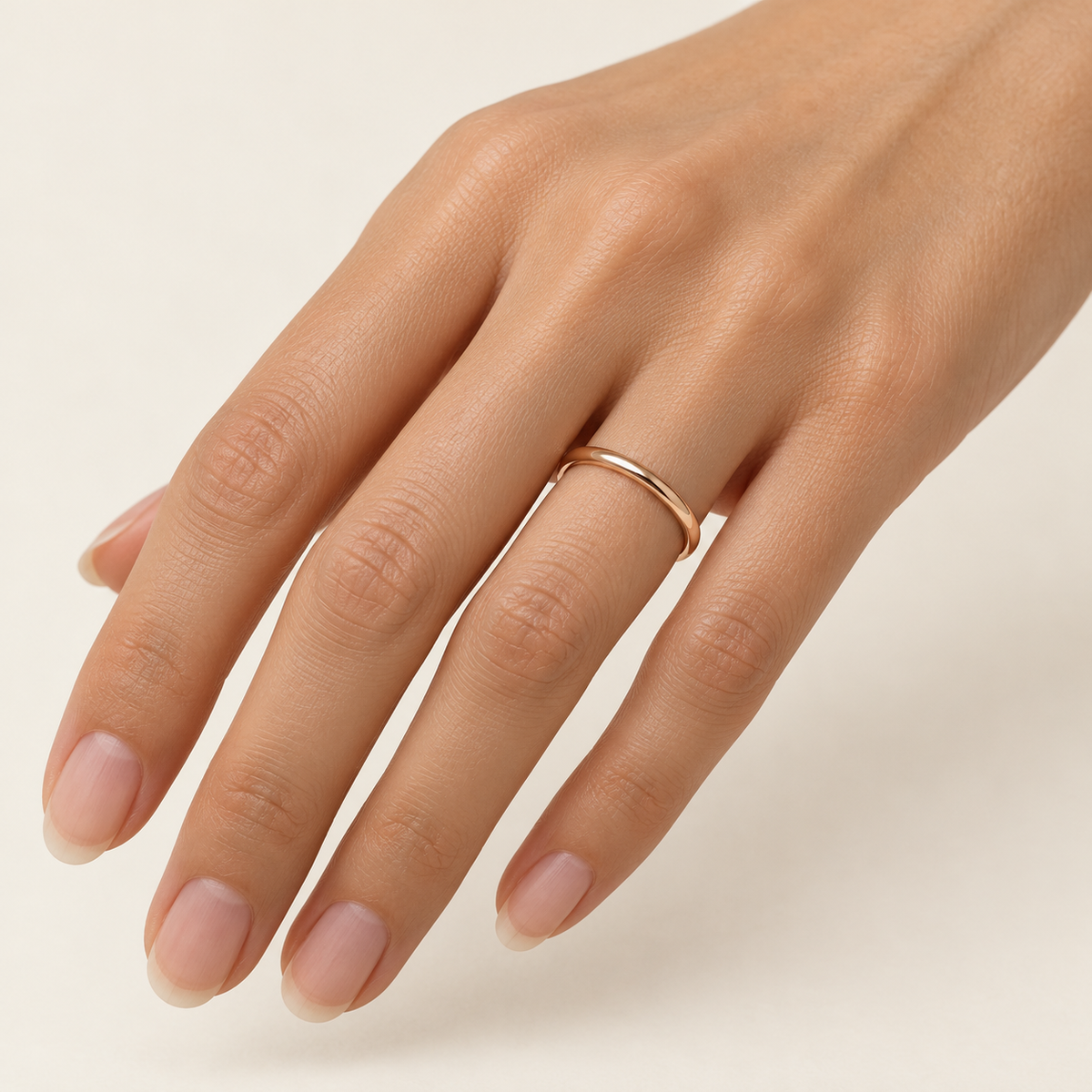 BASTION 2 mm — woman wearing an 18K rose gold wedding band, AI model illustration