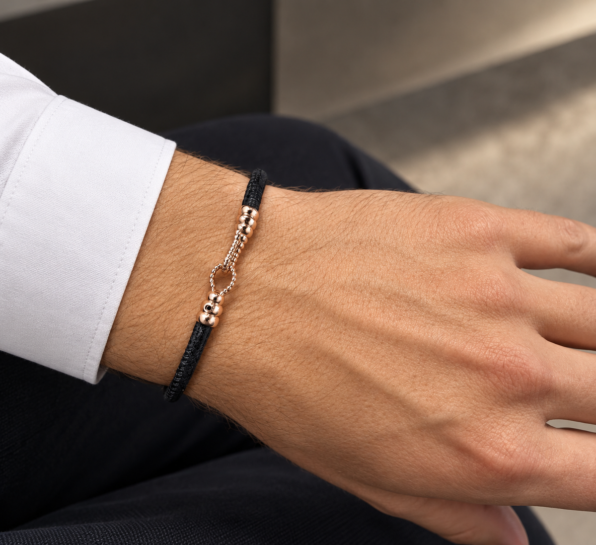 Molekule Hook Bracelet in Classic Black European calfskin with 9K rose gold hook, worn on the wrist