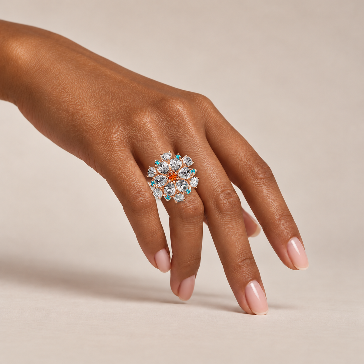 Ombrelle Barocco mandarin garnet and Paraíba tourmaline ring on raised hand