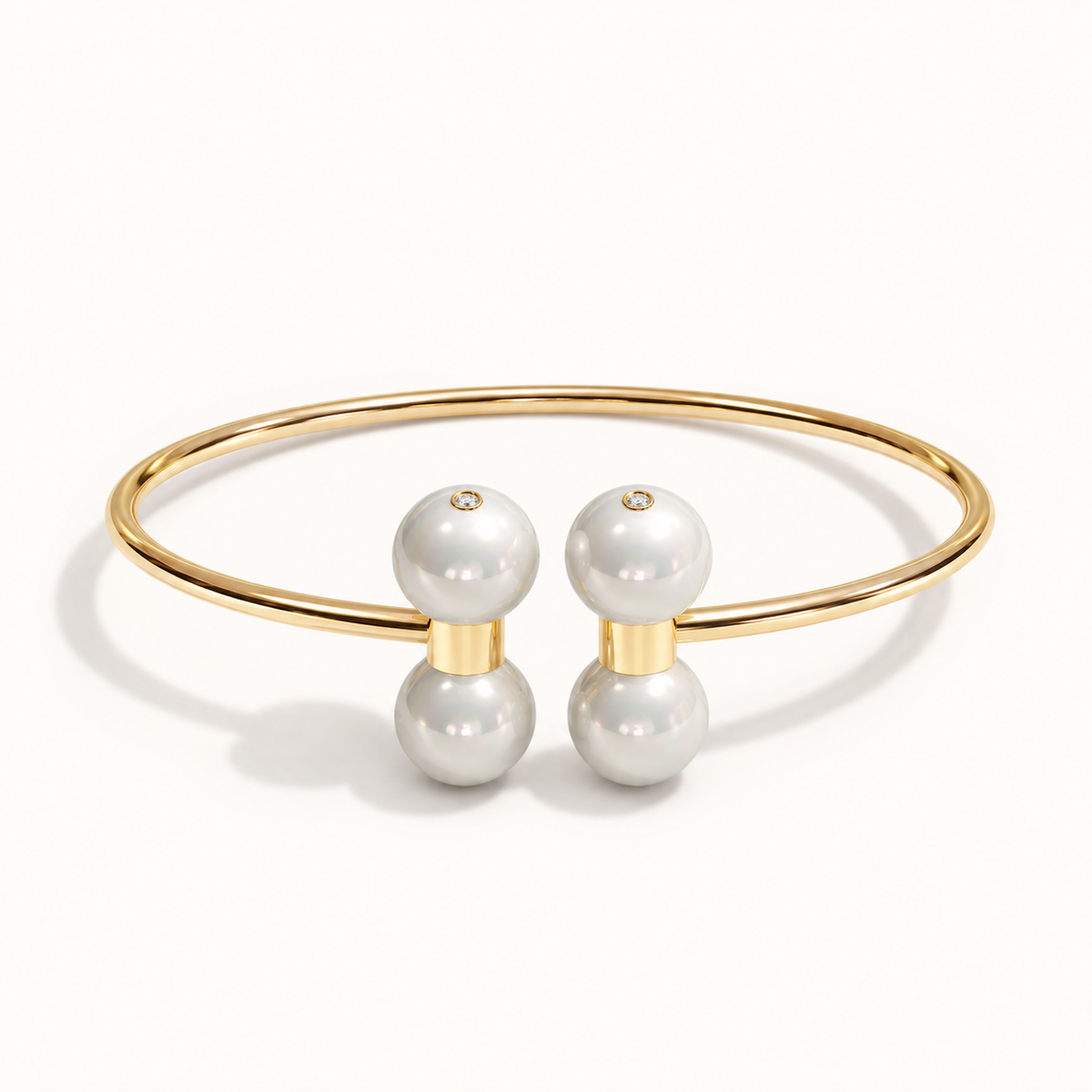 Barbelle Couple Bangle in 18K yellow gold with South Sea pearls and 0.01 ct bezel-set diamond accents — front view