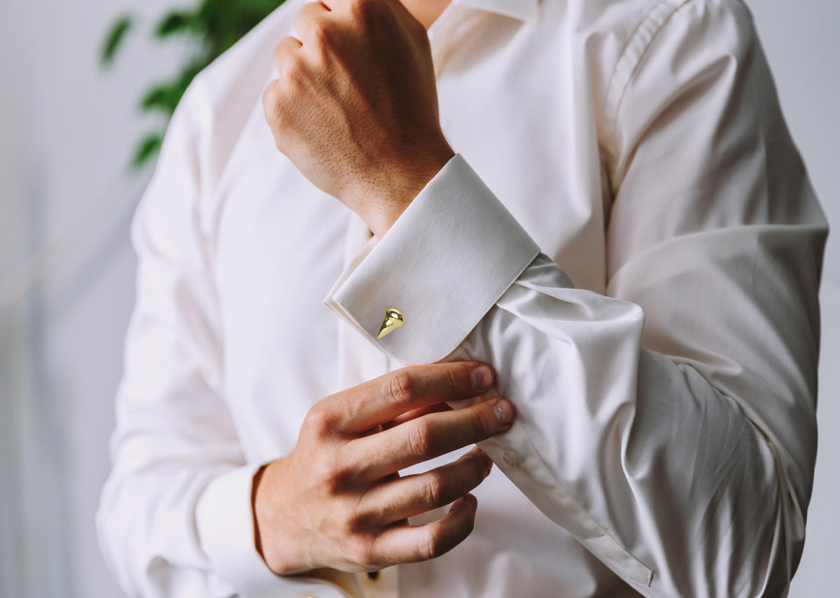 Les Griffe Cufflinks in 18K yellow gold, worn on a model