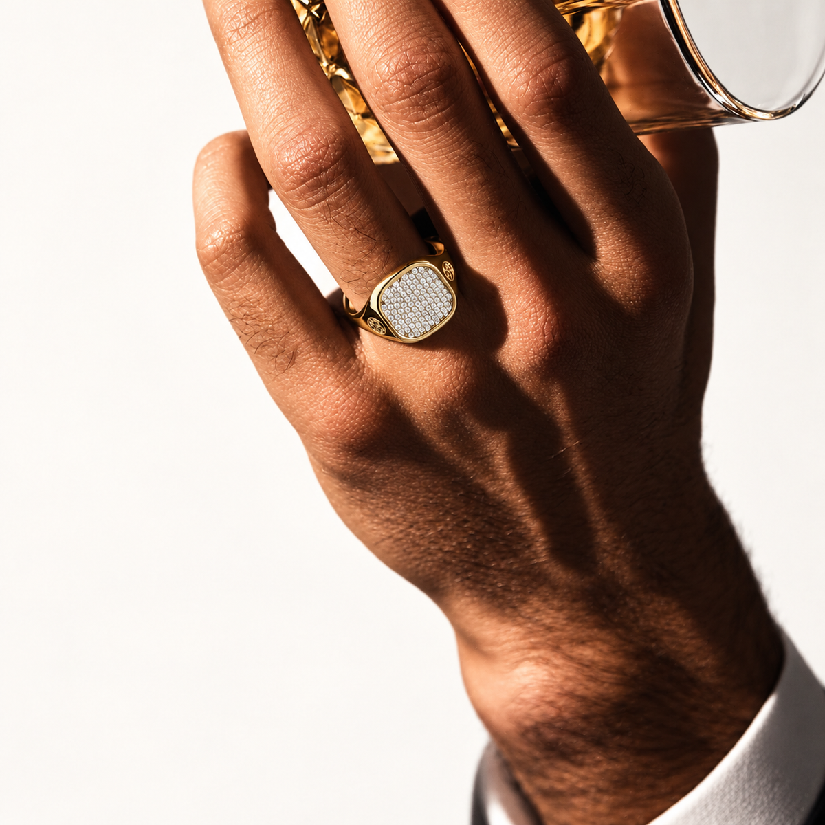 Monogram Signet Pavé Ring on hand in hard directional side lighting