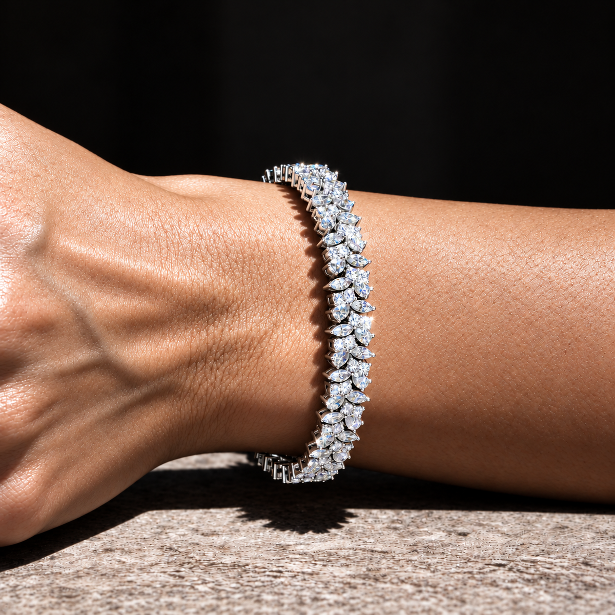 Diamond bracelet on a wrist photographed with strong direct flash